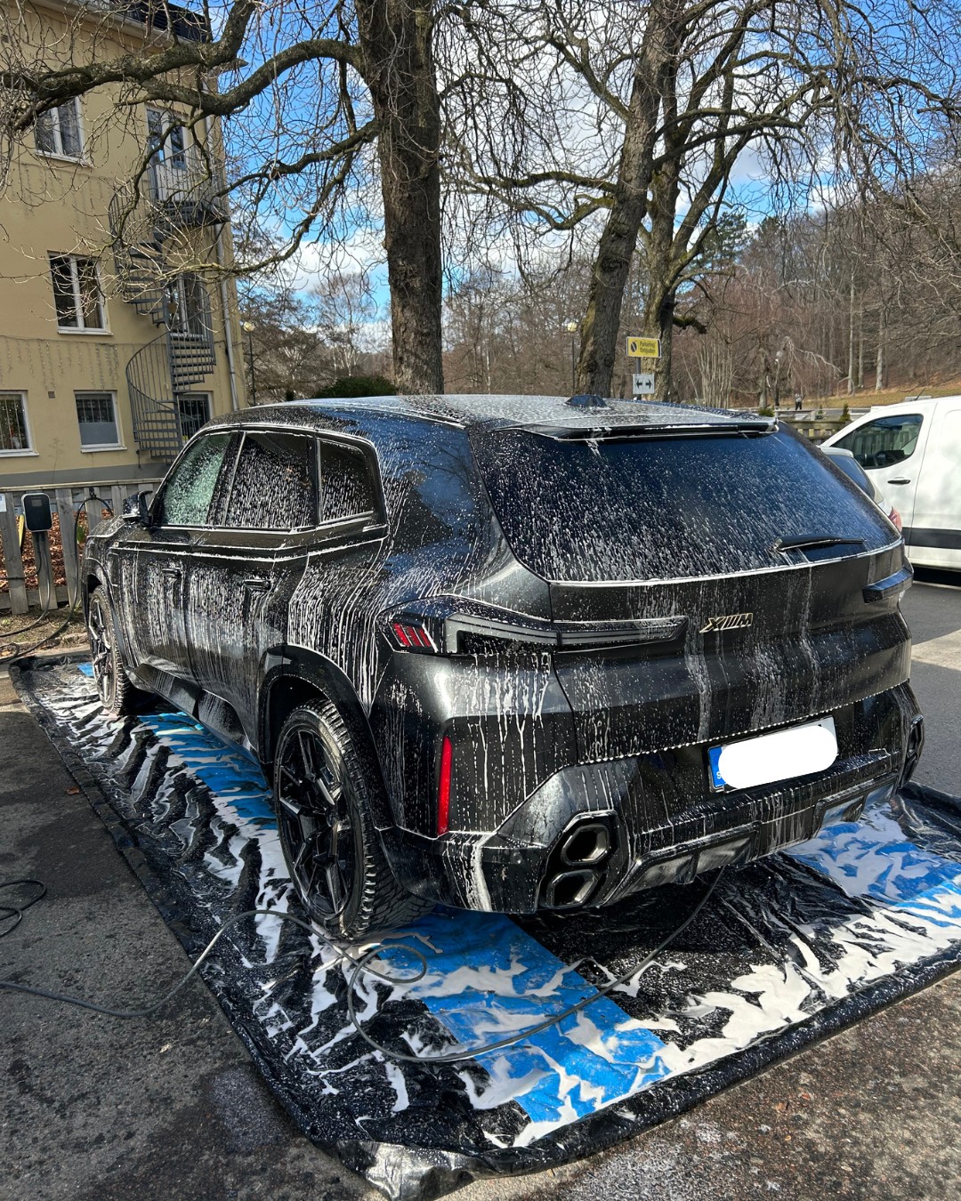 Bil under tvättens gång med skum